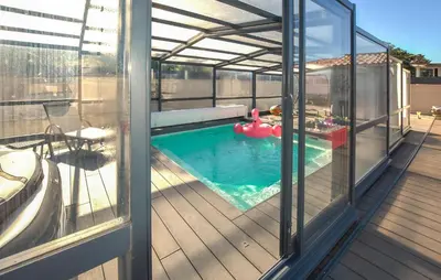 a house with a swimming pool on a deck at Villa Avec Piscine Privée in Carpentras