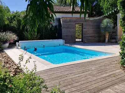 a swimming pool with a bench in a yard at La Canopée en Provence - Piscine, Vue sur le Mont Ventoux ! in Carpentras
