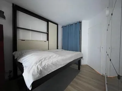 a bedroom with a large bed and a window at studio calme campagne in Aix-en-Provence
