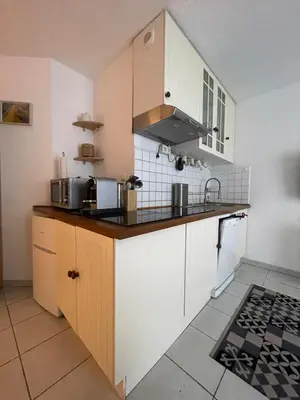 a kitchen with white cabinets and a counter top at studio calme campagne in Aix-en-Provence