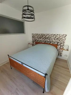 a small bed in a room with a tv at L'escale Cavaillonnaise in Cavaillon