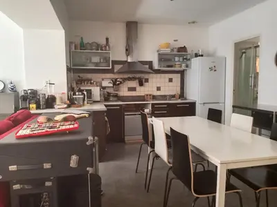 a kitchen with a table and a dining room at Quiet ground floor, air conditioning, garden, 3 bedrooms, 7 people max in Salon-de-Provence