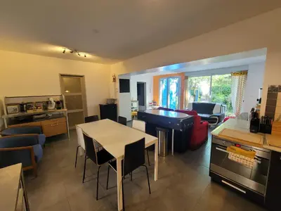 a kitchen and living room with a table and chairs at Quiet ground floor, air conditioning, garden, 3 bedrooms, 7 people max in Salon-de-Provence