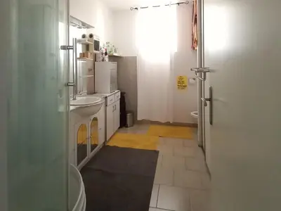 a bathroom with a sink and a washing machine at Quiet ground floor, air conditioning, garden, 3 bedrooms, 7 people max in Salon-de-Provence