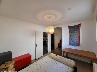 a living room with a couch and a table at Quiet ground floor, air conditioning, garden, 3 bedrooms, 7 people max in Salon-de-Provence