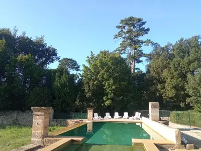 a swimming pool in a yard with two lawn chairs at Maison de famille dans les amandiers Provence 15 prs - Domaine de Ribbe in Rognes