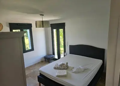 a bedroom with a bed with two towels on it at Les oliviers in Saint-Didier