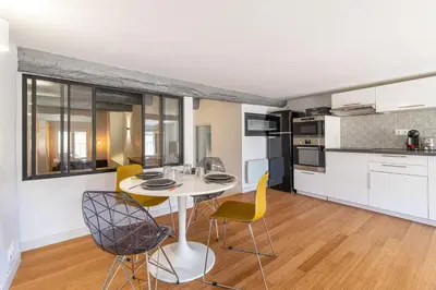 a kitchen and dining room with a table and chairs at Aixora - Centre historique - Tout à pied & parking in Aix-en-Provence