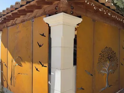 a building with a wall with birds painted on it at Les Tournillayres in Bédoin