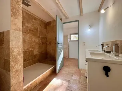 a bathroom with a shower and a sink and a tub at Mas d Anissa in Avignon