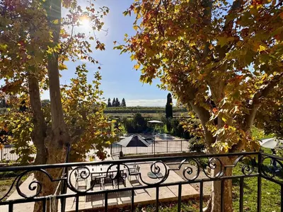 a view of a park with a bench and trees at Mas d Anissa in Avignon