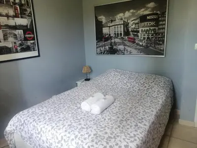 a bedroom with a bed with two towels on it at Villa provençale piscine, calme et confort in Saint-Cannat
