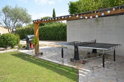 a ping pong table in front of a wall at Villa provençale piscine, calme et confort in Saint-Cannat