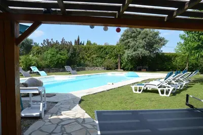 a pool with a bunch of chairs and a bunch ofitures at Villa provençale piscine, calme et confort in Saint-Cannat
