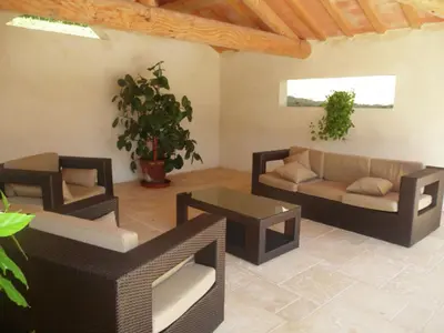 a living room with two couches and a table at Attractive Holiday Home in C reste with Pool in Céreste
