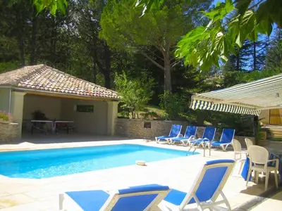 a group of chairs and a swimming pool with a table at Attractive Holiday Home in C reste with Pool in Céreste