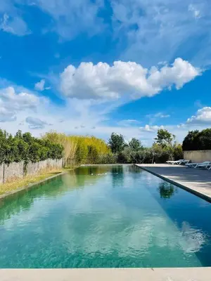 a swimming pool with turquoise water at Très joli studio prôche Lourmarin in La Celle-sous-Gouzon