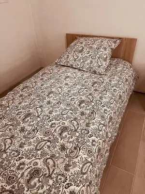 a bed with a comforter and a pillow at Duplex Cosy Aix proche CV terrasse clim parking in Aix-en-Provence