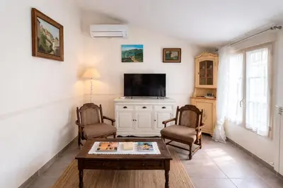 a living room with a coffee table and a tv at LaPetite Maison Abigail, Peaceful home in Avignon in Avignon