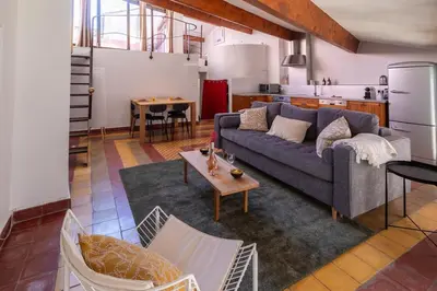 a living room with a couch and a table at Duplex avec terrasse, au cœur d'Aix-en-Provence in Aix-en-Provence