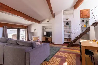 a living room with a couch and a table at Duplex avec terrasse, au cœur d'Aix-en-Provence in Aix-en-Provence