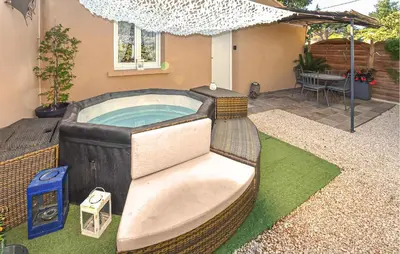 a hot tub in the backyard of a house at Maisonnette Avec Jacuzzi in Mazan