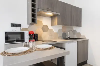 a kitchen with a counter with two plates on it at Le Rimbaud - Studio moderne en hypercentre - WiFi in Carpentras