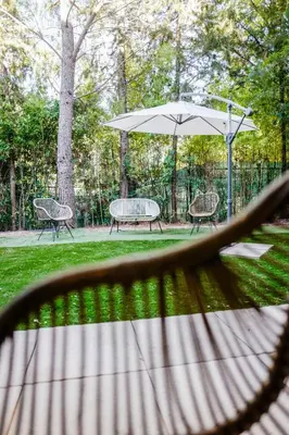 a table and chairs and an umbrella in a park at T2 cosy avec jardin & parking gratuit - Quartier Beauregard in Aix-en-Provence