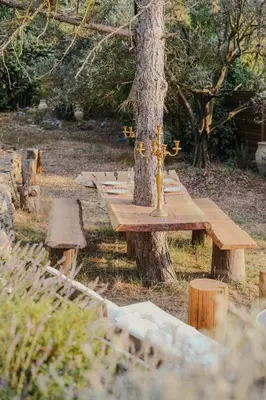 a wooden picnic table in front of a tree at Charming House At The Foot Of Luberon In Maubec in Maubec