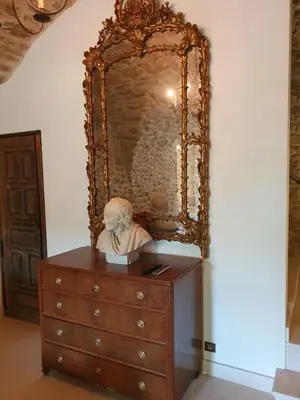 a dresser with a bust on top of it at Historic Mansion In Provence Vineyards in La Tour-dʼAigues