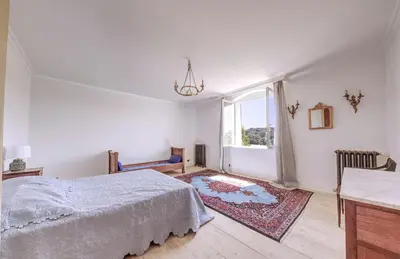 a white bedroom with a bed and a window at Historic Mansion In Provence Vineyards in La Tour-dʼAigues