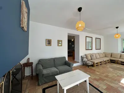 a living room with a couch and a table at Villa des Platanes - Maison provençale avec jardin, parking & barbecue au cœur du vignoble du Château de Barbebelle Rognes - Proche Aix-en-Provence - 6 personnes in Rognes