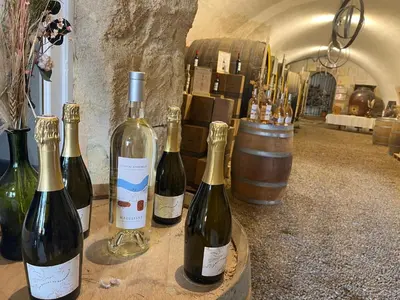 a group of bottles of wine sitting on a table at Villa des Platanes - Maison provençale avec jardin, parking & barbecue au cœur du vignoble du Château de Barbebelle Rognes - Proche Aix-en-Provence - 6 personnes in Rognes