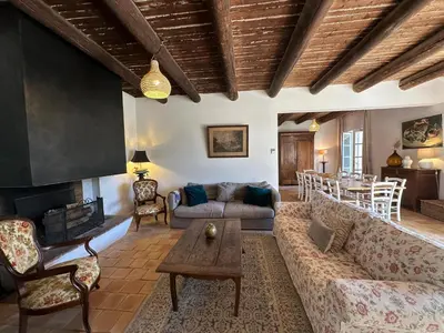 a living room with a couch and a fireplace at Villa du Puits - Séjour en Provence avec piscine privée & jardin au cœur d'un domaine viticole Château de Barbebelle - Rognes - Proche d'Aix-en-Provence -10 personnes in Rognes