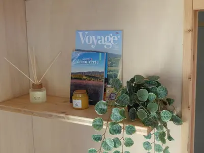 a shelf with a book and a plant on it at Tiny House avec vue sur le rocher de Saignon, Luberon in Saignon
