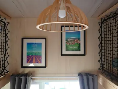 a chandelier and pictures on the wall of a restaurant at Tiny House avec vue sur le rocher de Saignon, Luberon in Saignon