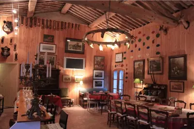 a dining room with tables and chairs and a chandelier at Studio Ouest - Chambre avec vue vignoble - Domaine viticole Château Barbebelle Rognes - Proche d'Aix-en-Provence in Rognes