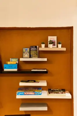 a book shelf with books and plants on it at Evasion au centre d Aix loft chic et cosy in Aix-en-Provence