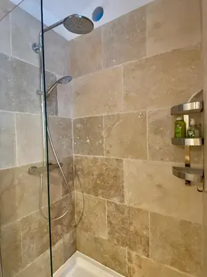 a bathroom with a shower with a glass door at Les Iris in Bonnieux