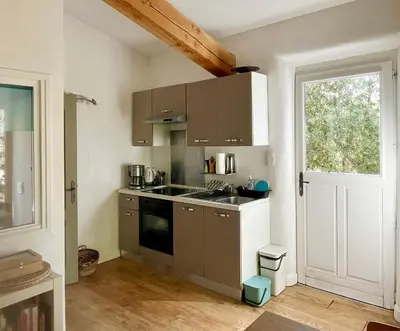 a kitchen with a sink and a stove at Les Iris in Bonnieux