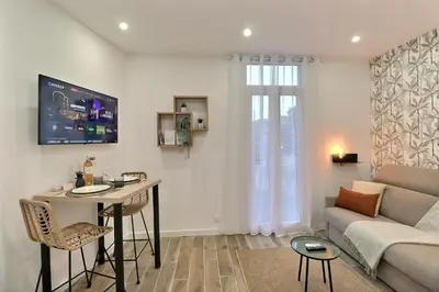 a living room with a couch and a table at La Parenthèse Aixoise - 3 stars - Parking - Clim in Aix-en-Provence