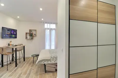 a room with a bed and a table in a room at La Parenthèse Aixoise - 3 stars - Parking - Clim in Aix-en-Provence