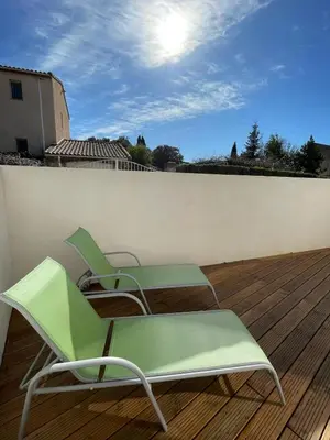 two green chairs sitting on top of a wooden deck at Tiny house avec terrasse privée - Parking - Fibre TV in Lambesc