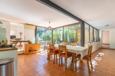 a kitchen and dining room with a table and chairs at Villa sur Domaine Aix - Piscine & Tennis - Wagner in Aix-en-Provence