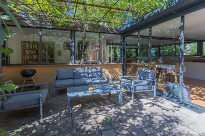 a patio with a couch and chairs and a table at Villa sur Domaine Aix - Piscine & Tennis - Wagner in Aix-en-Provence