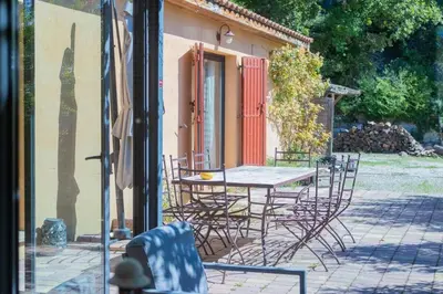 a table and chairs in front of a house at Villa sur Domaine Aix - Piscine & Tennis - Wagner in Aix-en-Provence