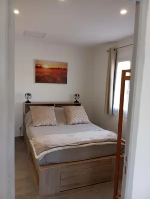 a bedroom with a bed in a room at Tiny House T1 in Entraigues-sur-la-Sorgue