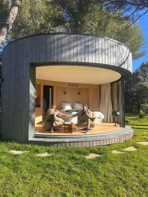 two people sitting in a circular building in the grass at Haras de Castellane in Pertuis