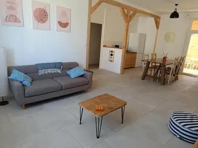 a living room with a couch and a table at La Villa des Trois in Cavaillon