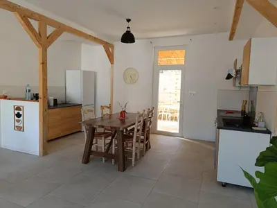 a kitchen and dining room with a table and chairs at La Villa des Trois in Cavaillon